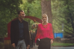 Stephen Wilson and Sarah Clarke walk past the red arch sculpture to the gala.