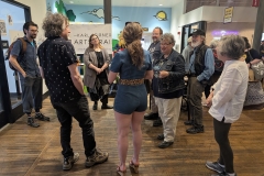 People stand together in Easton Public Market during the Poem From Your Pocket event.