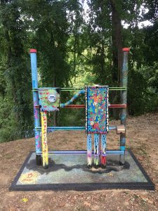 A view from the front side of the sculpture titled Electric on the Karl Stirner Arts Trail in Easton, Pennsylvania, featuring an electricity meter with shapes on it created by paint and marker.