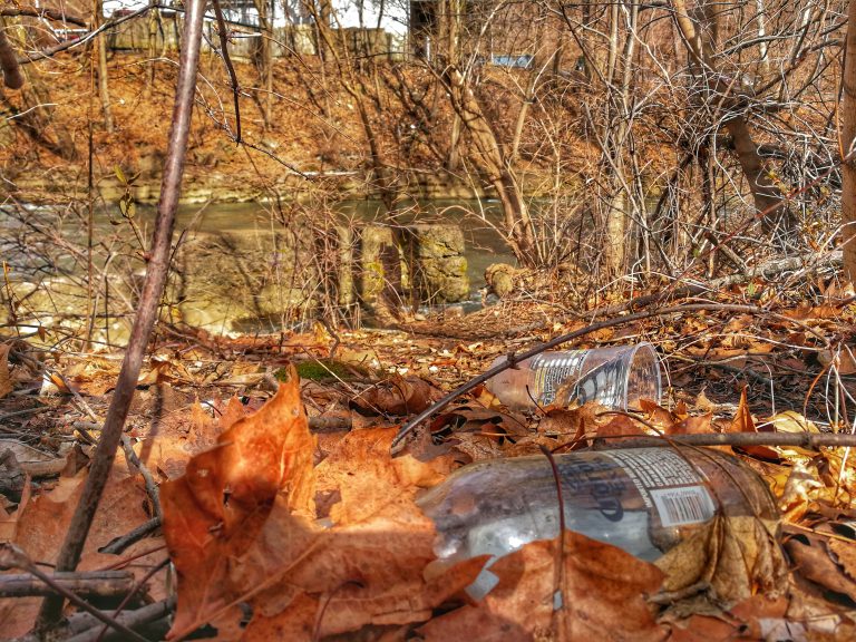 An empty cup and a liquor bottle on the ground on the Karl Stirner Arts Trail in Easton, Pennsylvania.