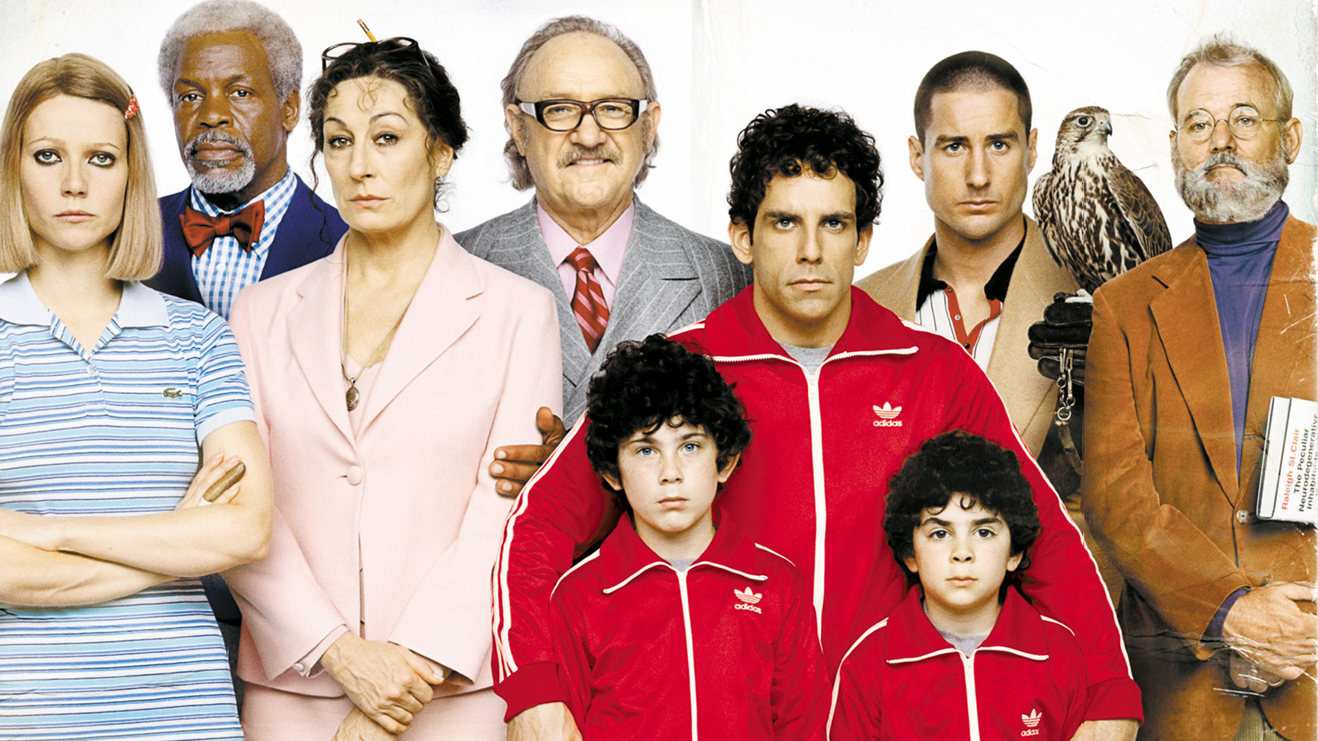 A group photo of nine characters and a bird from the film The Royal Tenenbaums