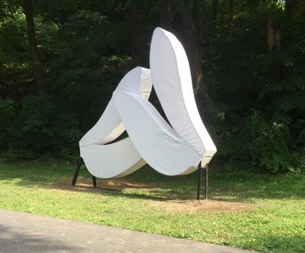 The outdoor sculpture Love Motel for Insects, which consists of two giant white shapes resembling bugs' wings.