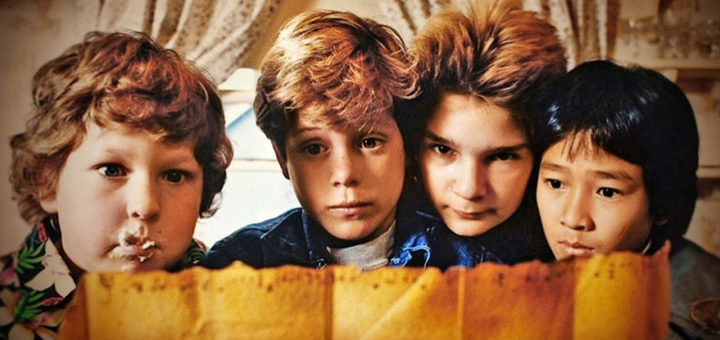 Four boys close to one another in a scene from the film The Goonies