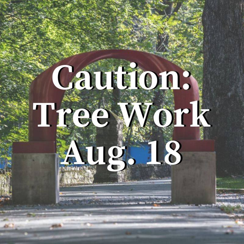 The red arch sculpture backgrounds the words, Caution: Tree Work Aug. 18