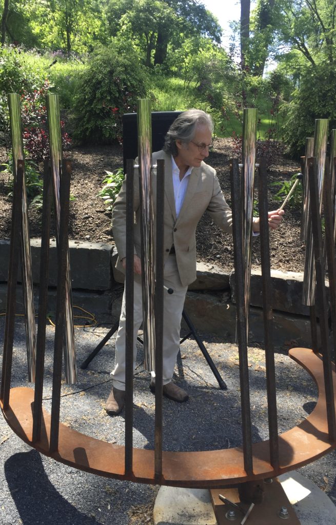 Max Weinberg, the longtime drummer for Bruce Springsteen's E Street Band, plays the Musical Path chimes during the dedication of the installation on the Karl Stirner Arts Trail in Easton, Pennsylvania.