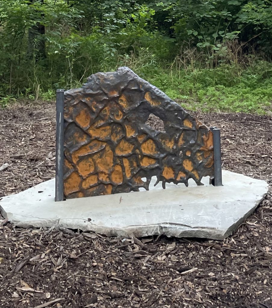 Made of rock and cast iron, the sculpture called Upriver: Mudcracks, one of five pieces in the Upriver installation by artist Heidi Wiren Bartlett, stands on the Karl Stirner Arts Trail in Easton, Pennsylvania.