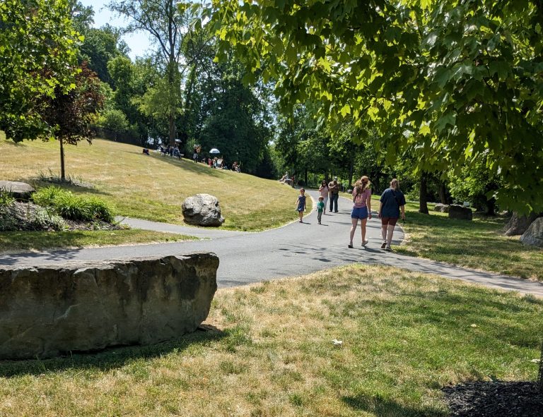 Several people walk during a sunny day on the Karl Stirner Arts Trail in Easton, Pennsylvania