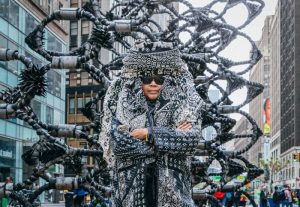 Chakaia Booker stands in front of one of her large-scale sculptures in New York City.