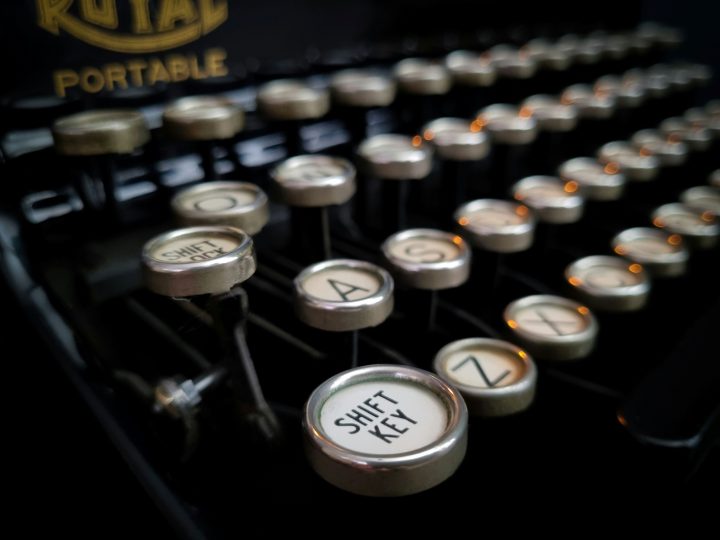 A closeup photo of a manual typewriter showing a portion of the keys