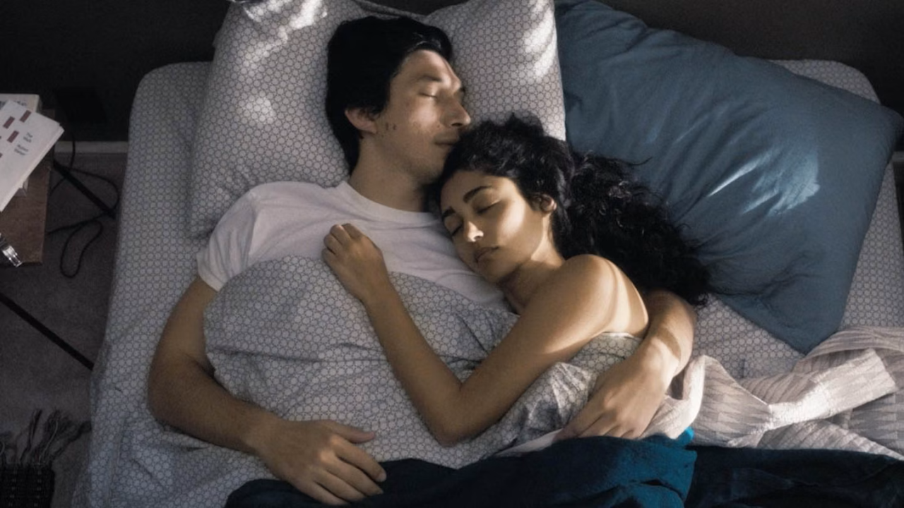 A couple lay asleep in bed together in a scene from the movie Paterson starring Adam Driver